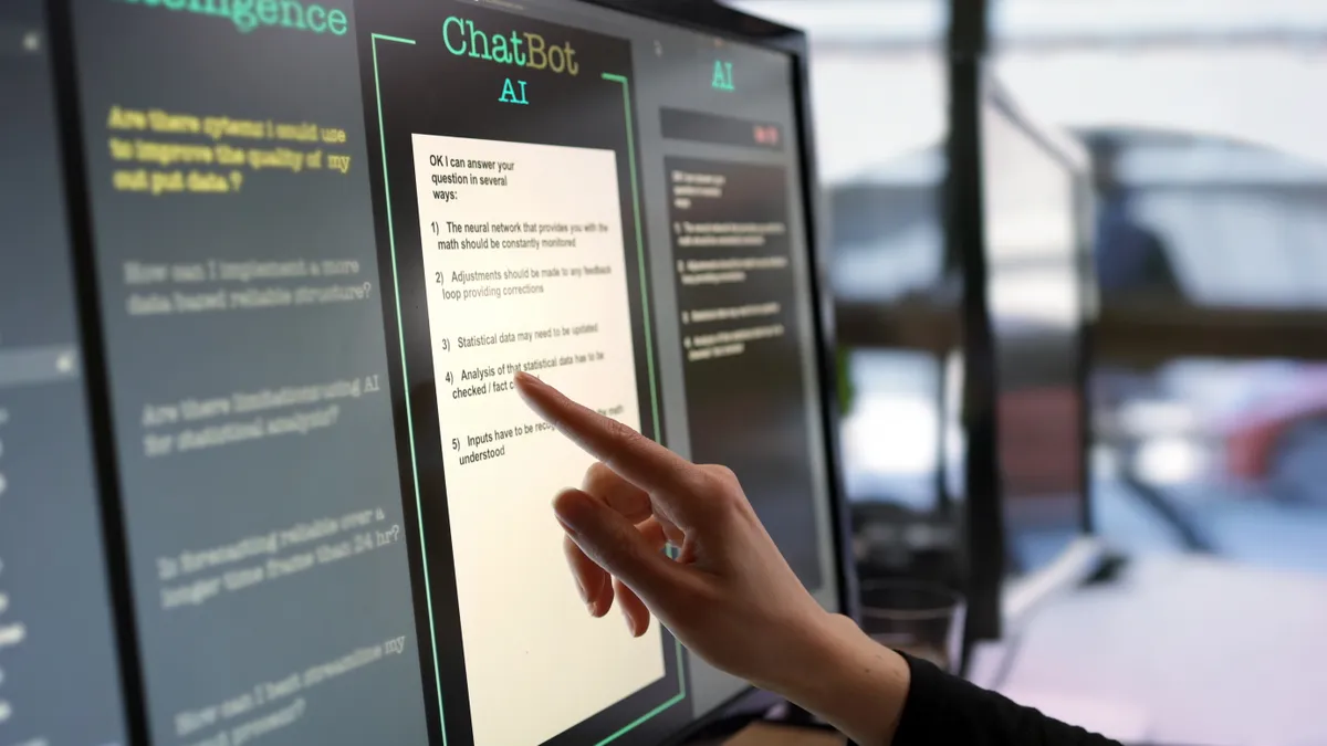 A person points at a touchscreen, ready to press, which features AI chatbot prompts.