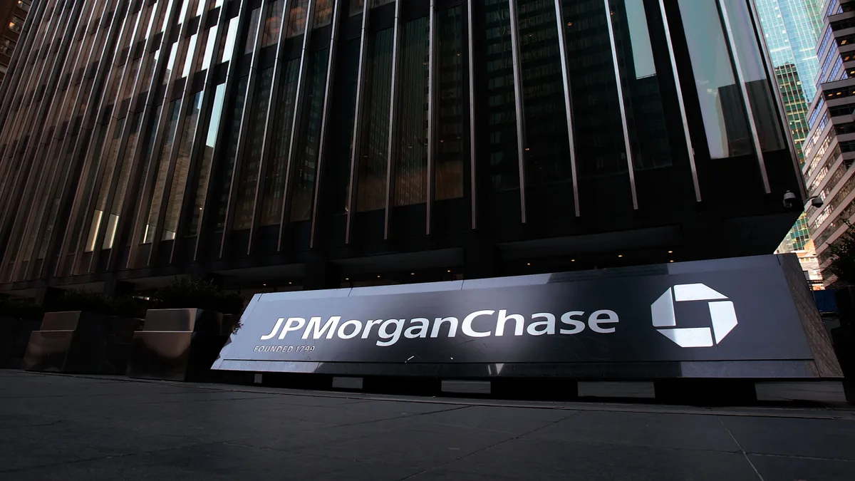 JPMorgan Chase sign in front of building in street level view.