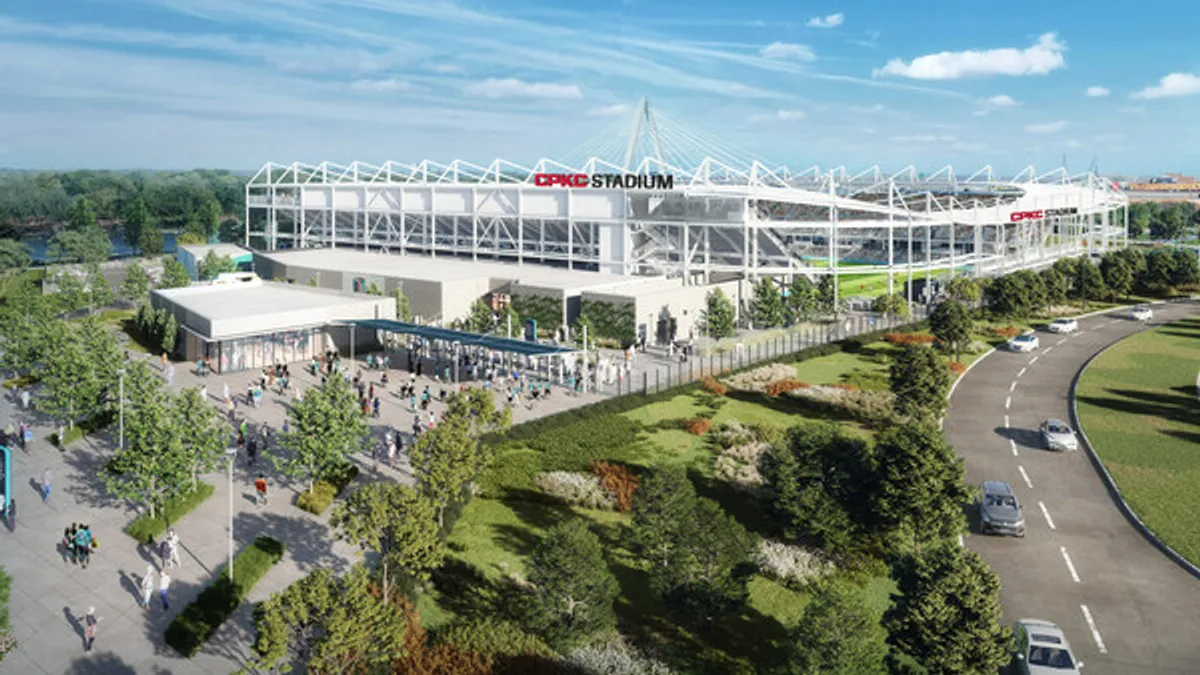 A rendering of the exterior of a stadium by a park.